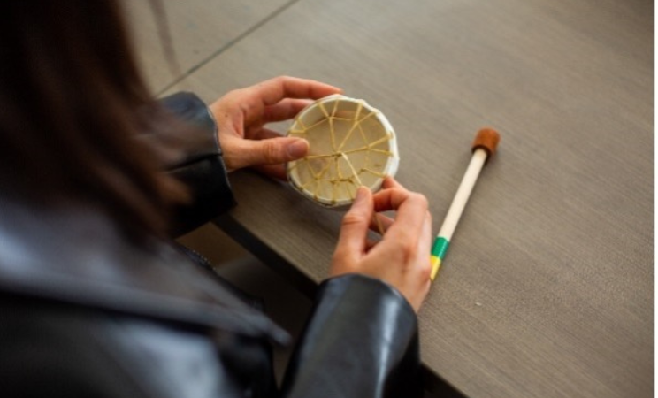 Women participating in an indigenous drum making workshop at Foundry Sea to Sky